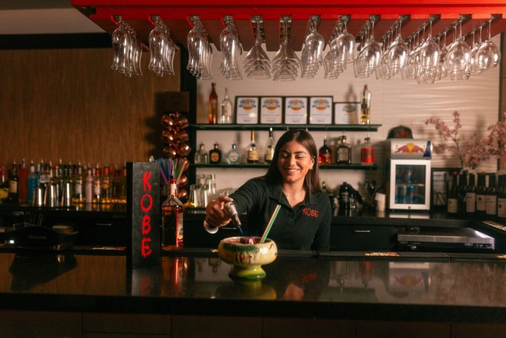 Bartender creating drink, "Volcano for Two"