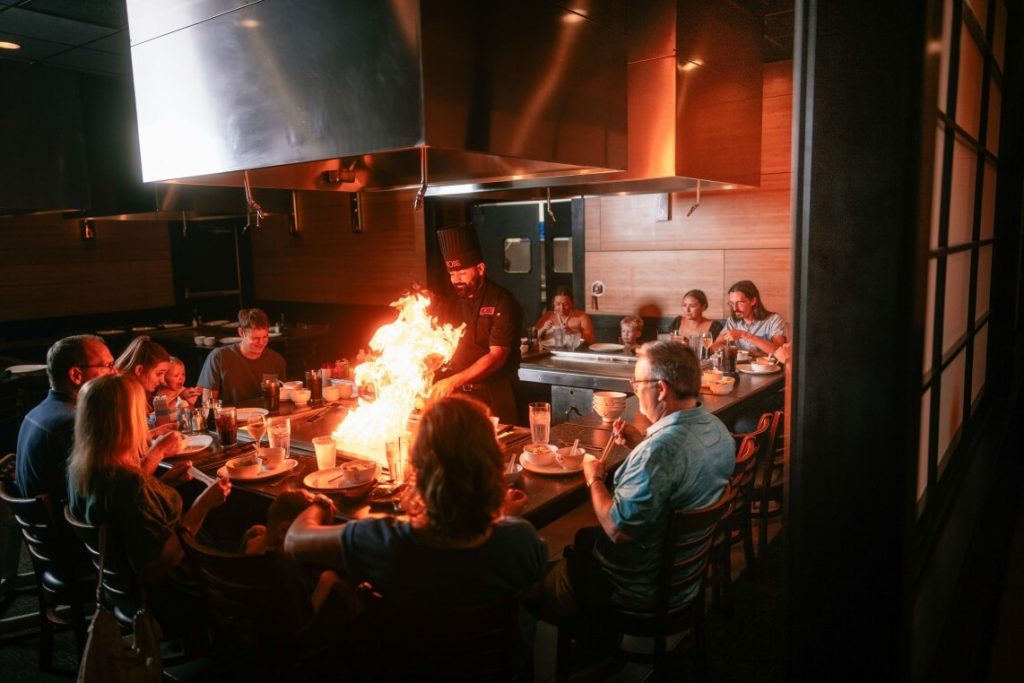 Kobe chef cooking on teppanyaki grill for group